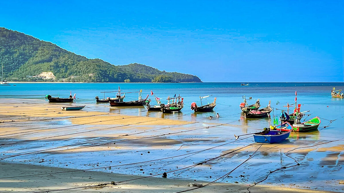Boats on shore of beach in Thailand