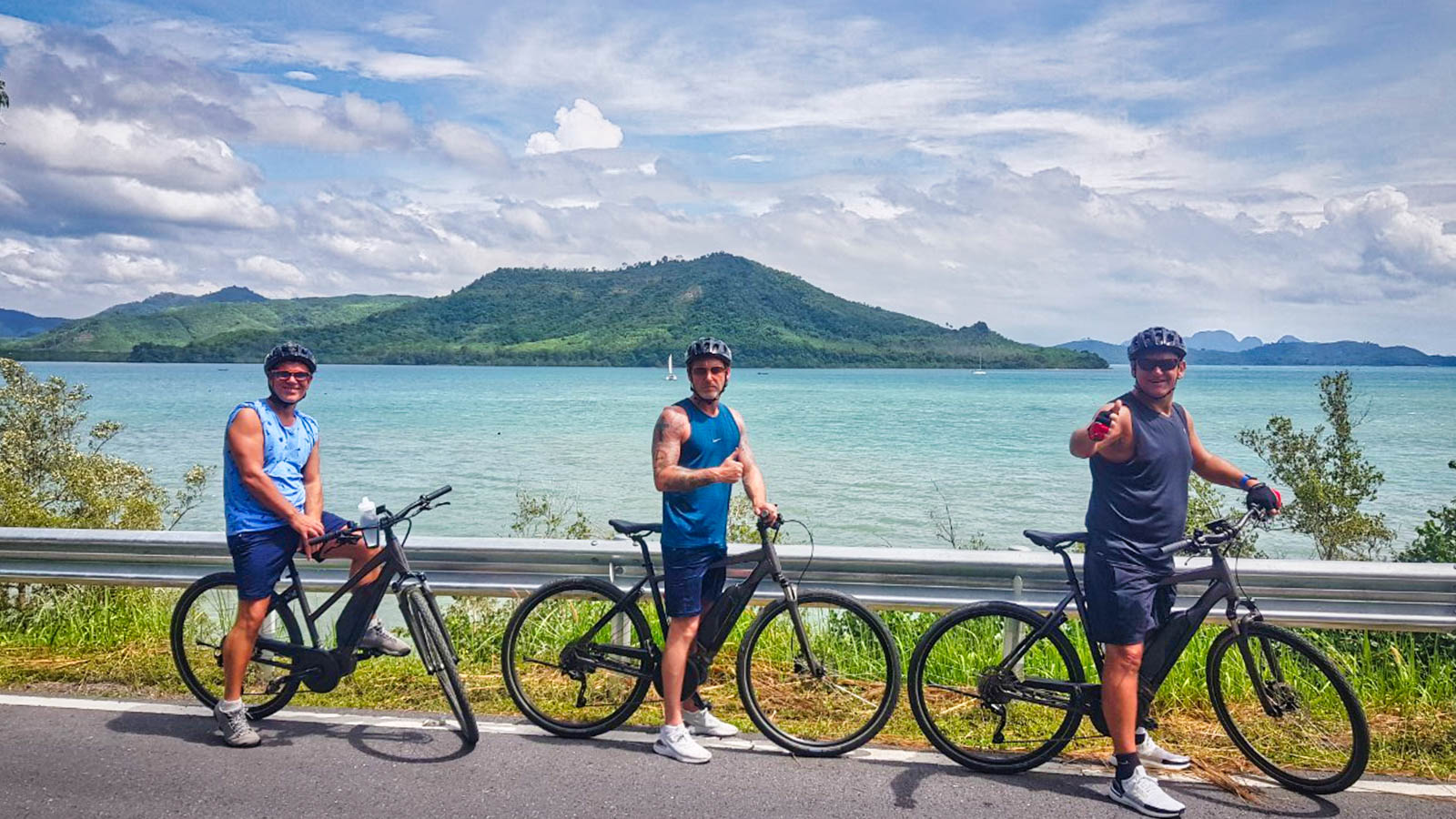 Cyclists posing on East Coast of Phuket Thailand