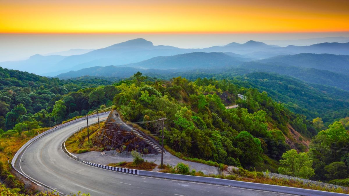 Road leading to mountains in Thailand during sunset